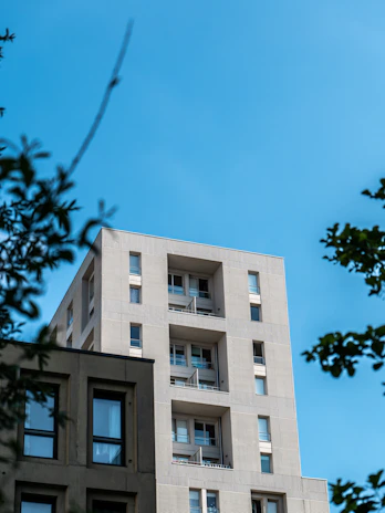 A panoramic view of a completed apartment building with balconies and large windows.