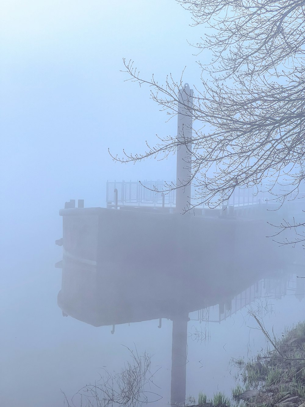 a boat in the water on a foggy day