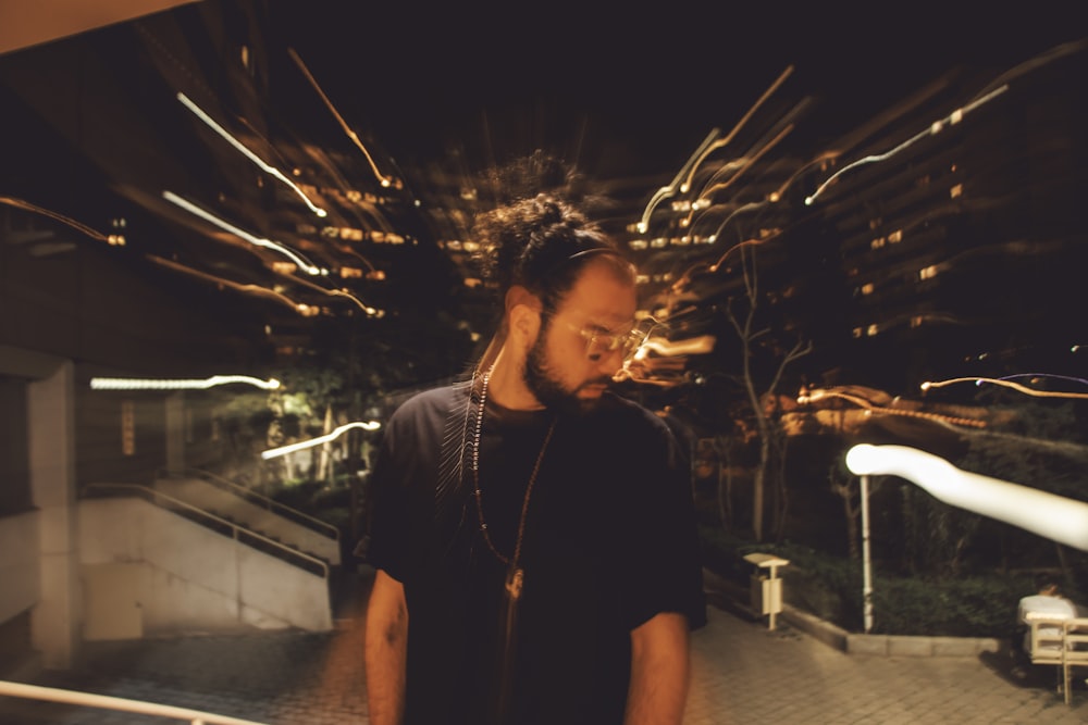 a man standing in front of a building at night