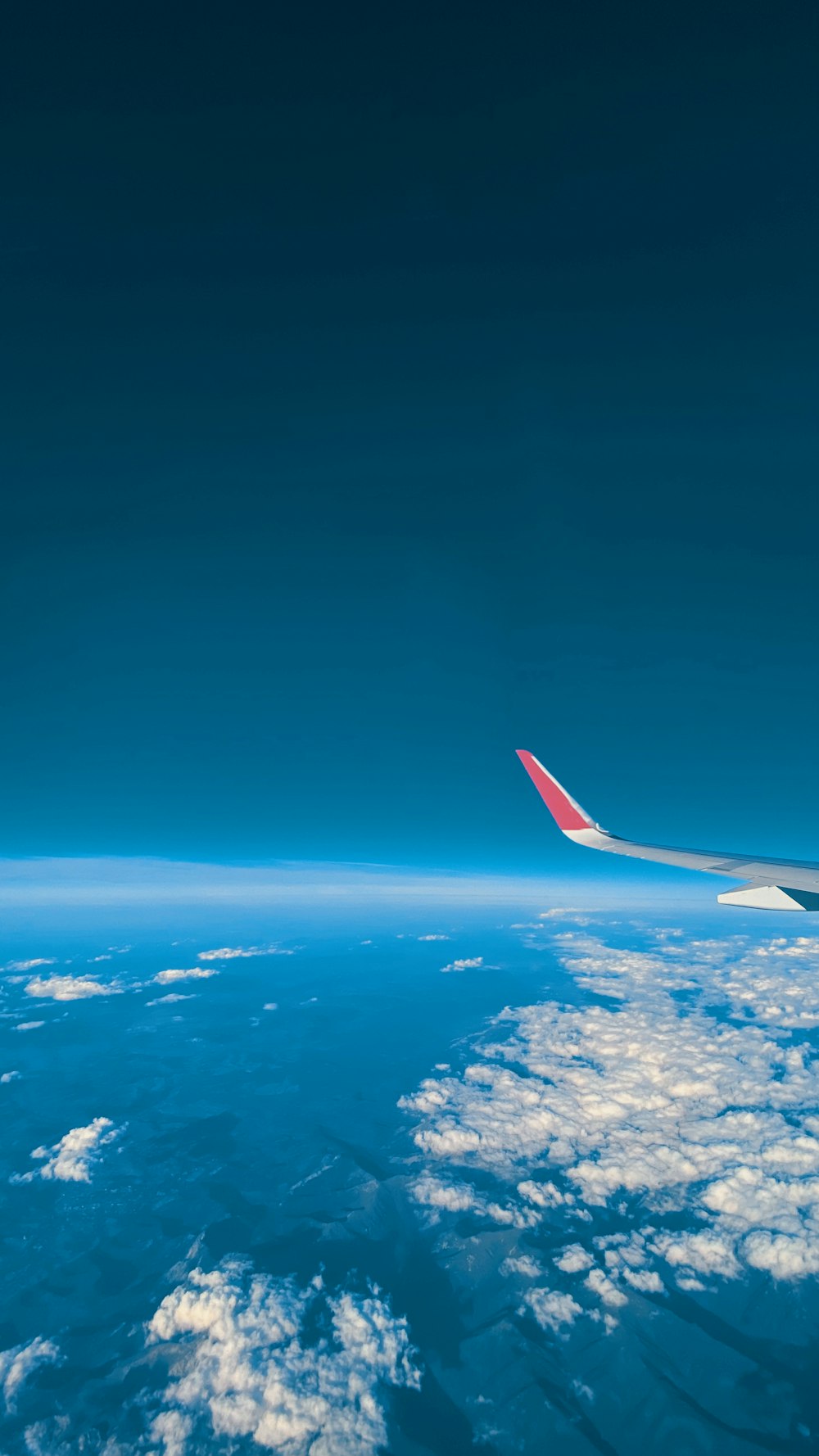 a view of the wing of an airplane in the sky