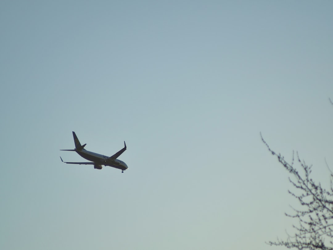 a large jetliner flying through a blue sky,