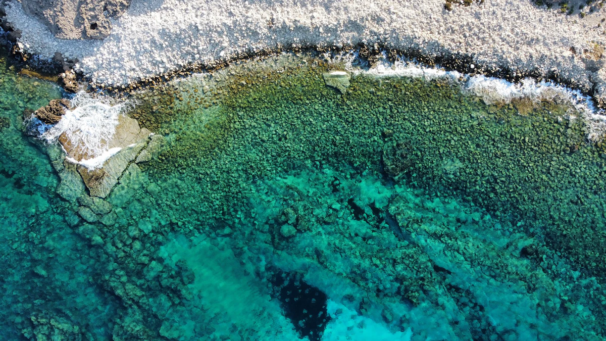Aerial view of a wide, busy sandy beach along the coast, illustrative of Pernera Beach, Protaras, Cyprus
