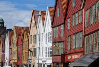 a row of buildings with a clock tower in the background