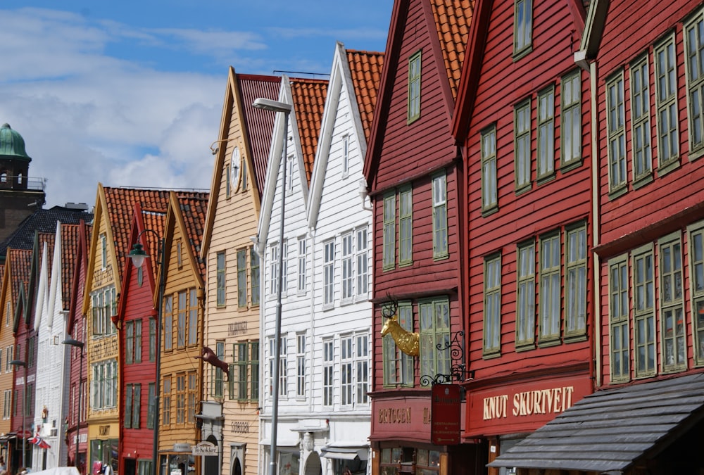 a row of buildings with a clock tower in the background