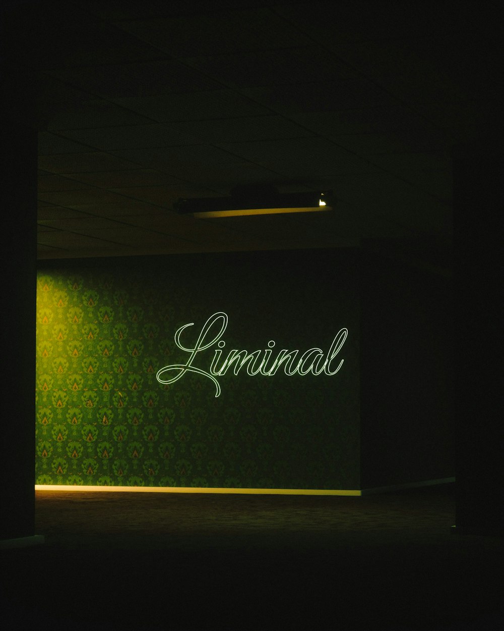 a dark room with a neon sign on the wall