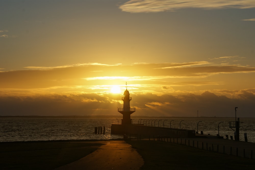 the sun is setting over a body of water