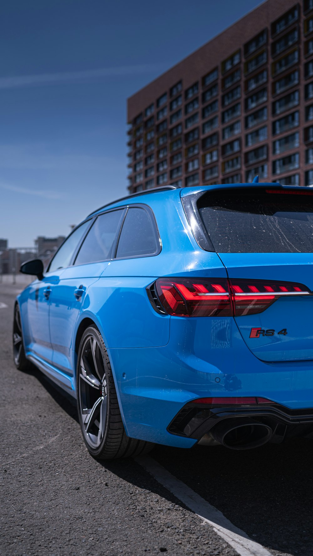 a blue car parked in a parking lot