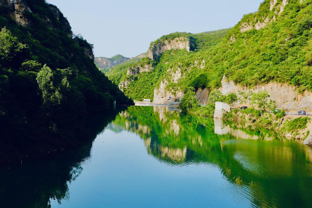 a body of water surrounded by mountains and trees