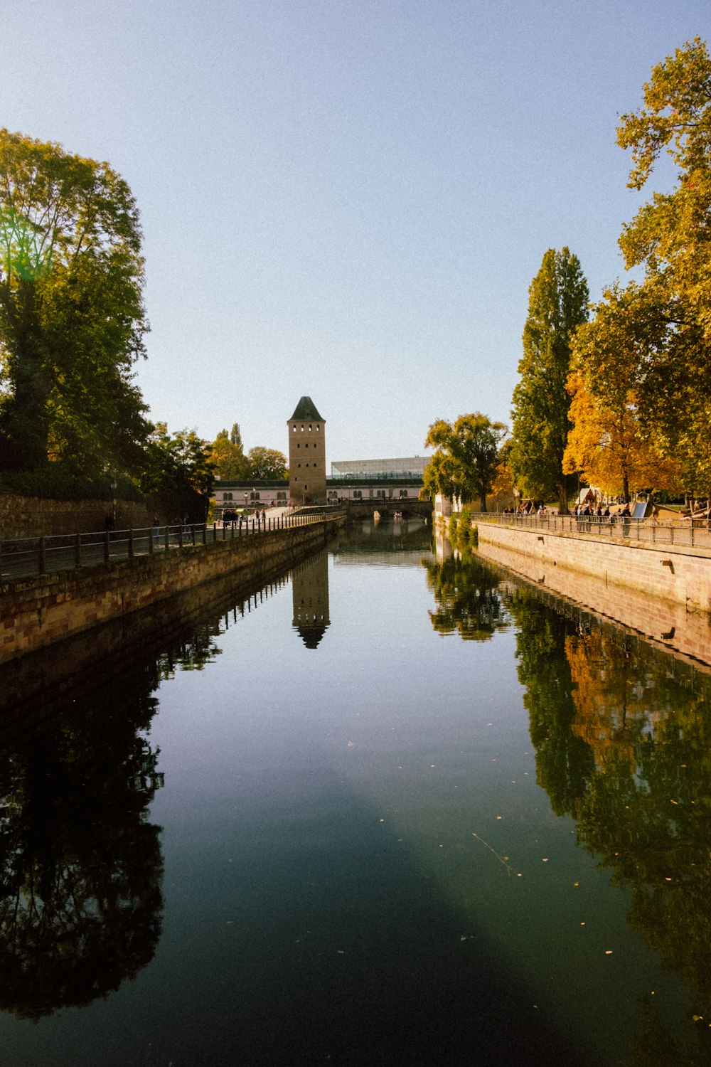 a body of water with a clock tower in the background