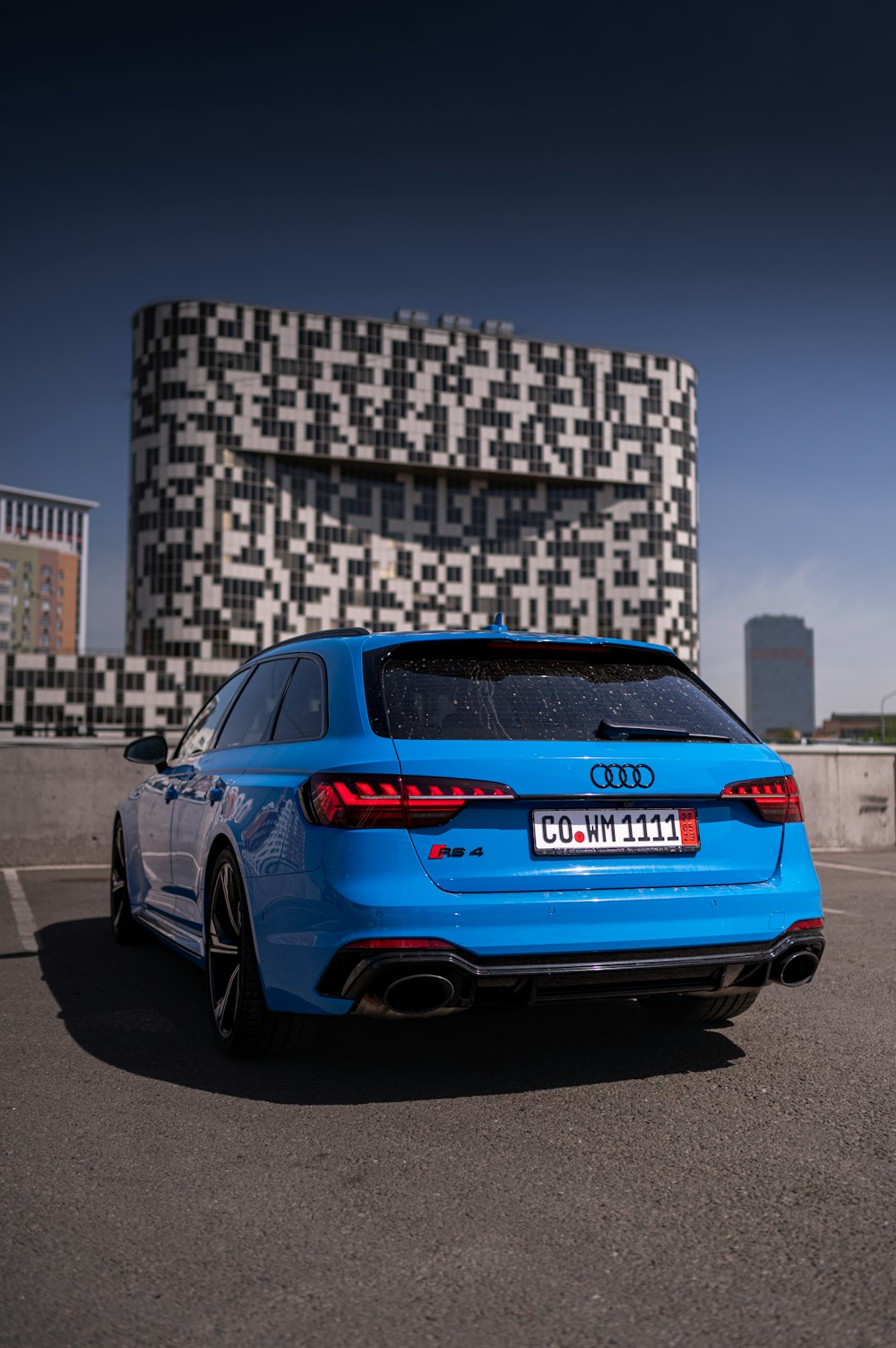 a blue car parked in front of a building