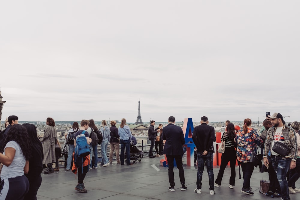 a group of people standing on top of a roof