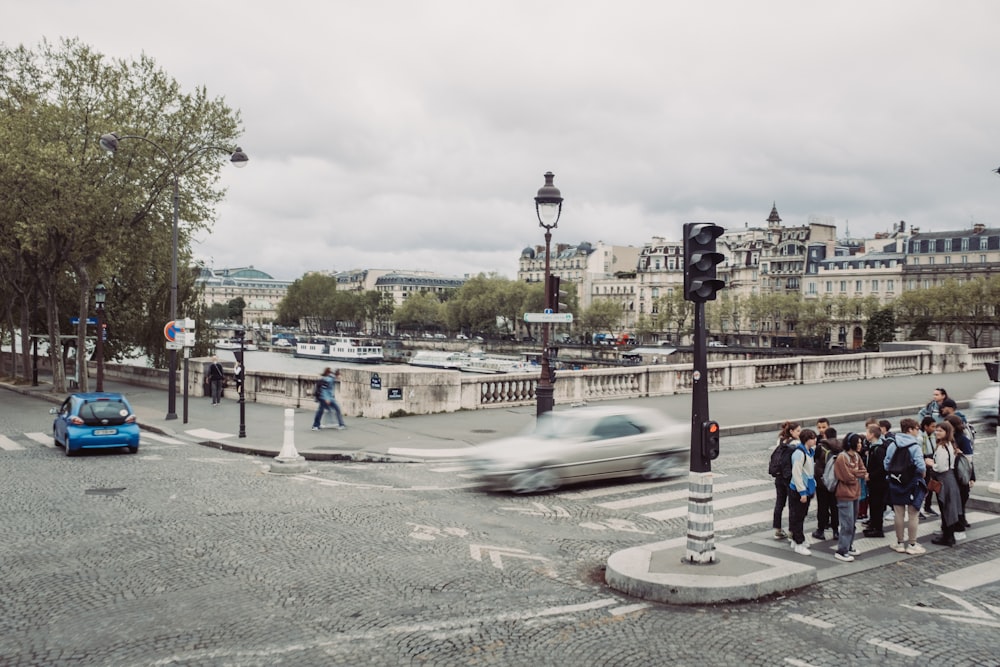 a group of people waiting to cross the street