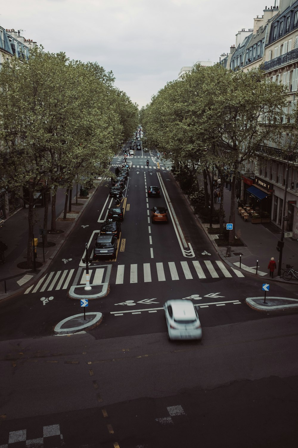 a city street with cars parked on both sides of the street