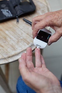 a person using an electronic device to measure sugar levels.