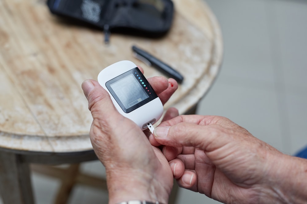 a person holding a small device in their hands