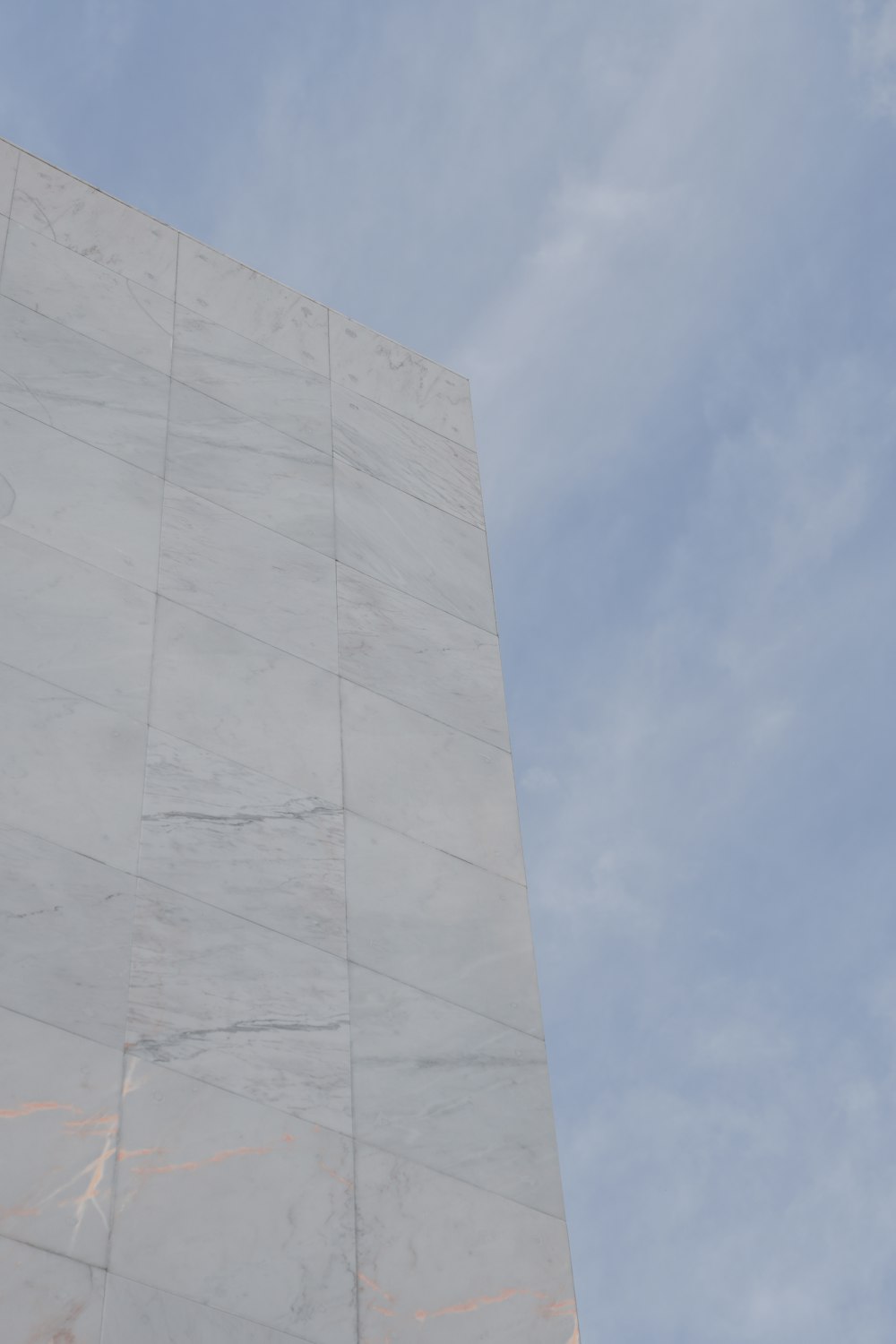 a tall white building with a clock on it's side