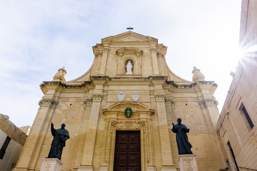 a church with statues of people in front of it