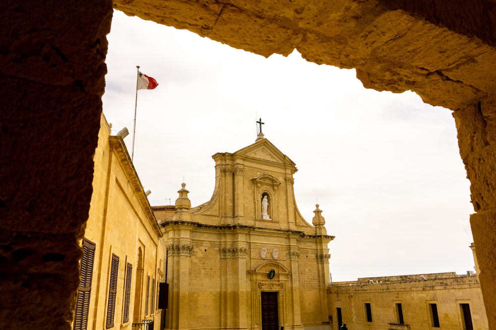 an old building with a cross on the top of it