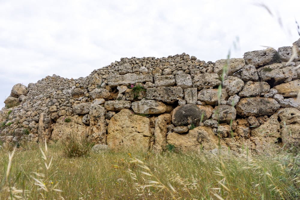 a stone wall made of rocks and grass