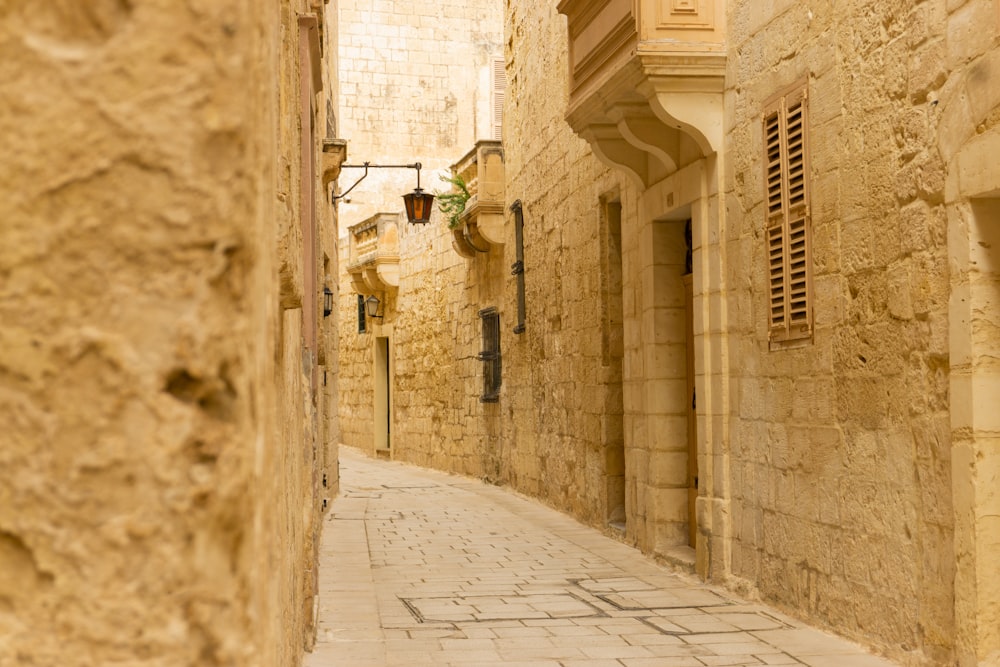 a narrow street with stone buildings on both sides