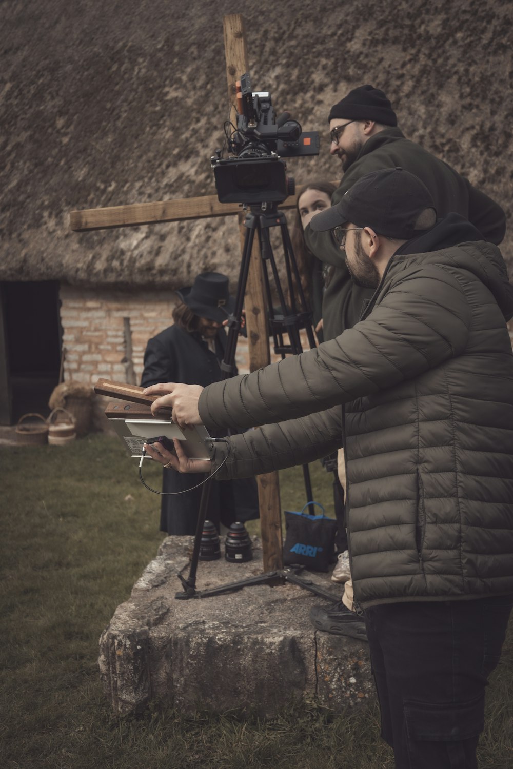 a man holding a tablet in front of a camera