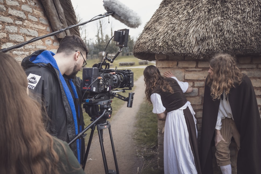 a group of people standing around a camera