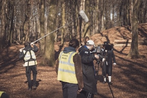 a group of people in the woods with a camera