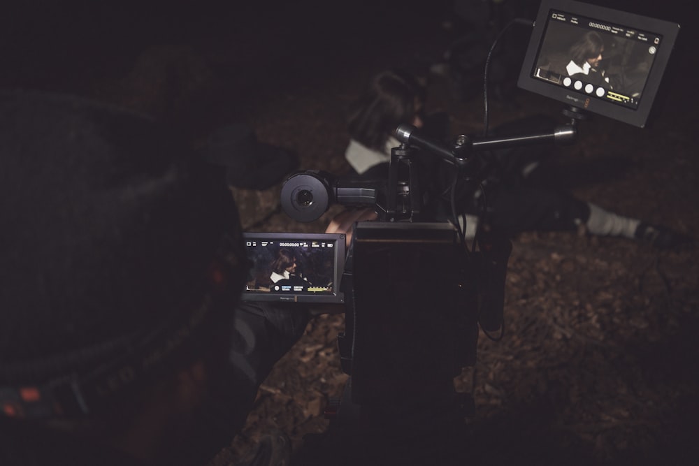 a person holding a camera in front of a camera