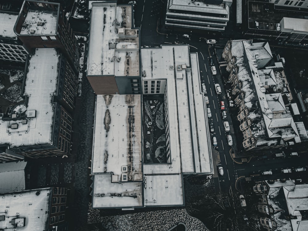 an aerial view of a building with snow on the ground