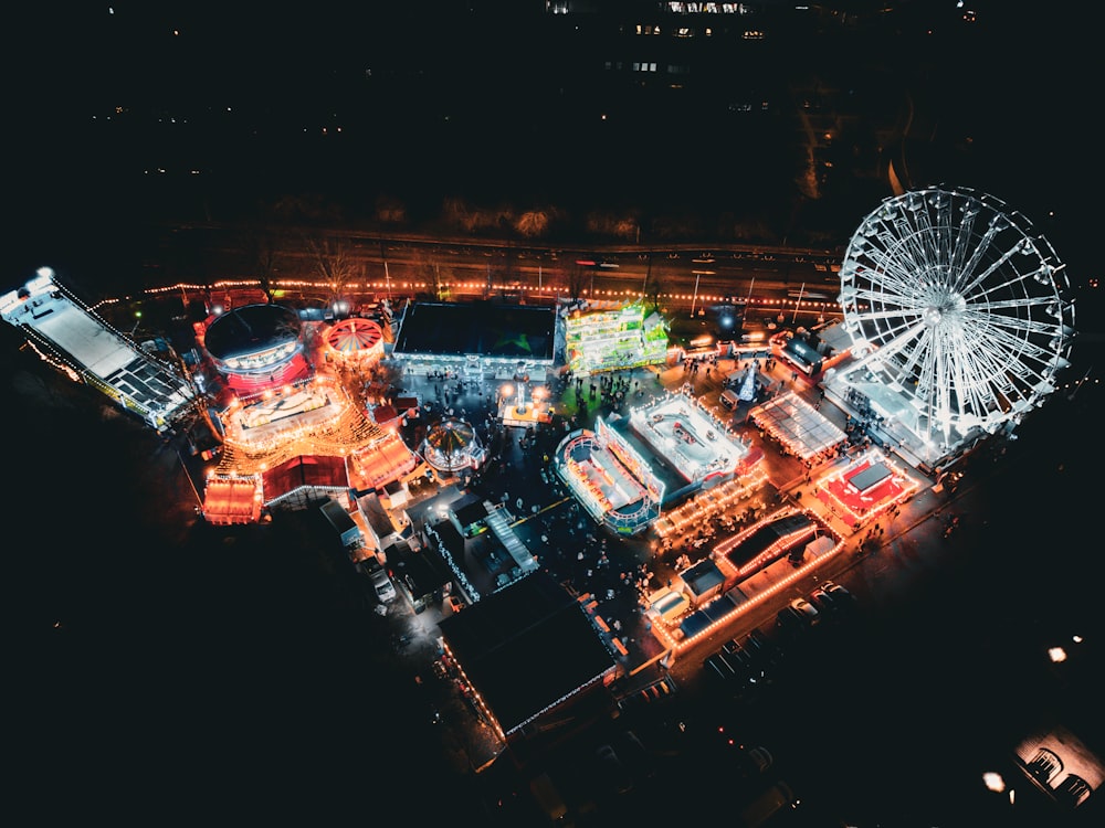 an aerial view of an amusement park at night