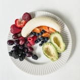 A colorful plate of fresh fruits and vegetables arranged neatly, symbolizing mindful eating habits.