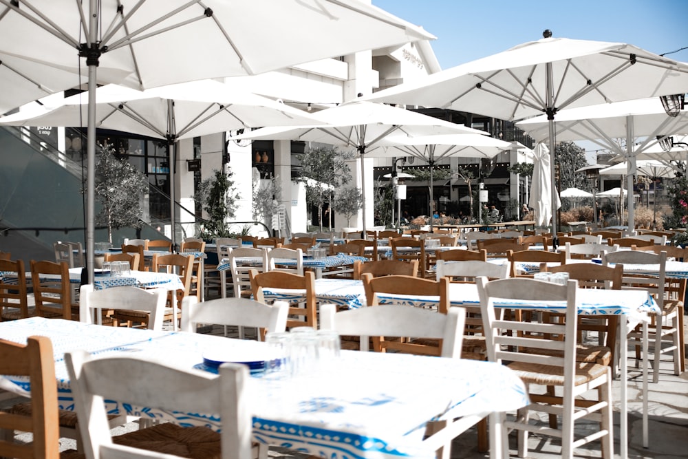 an outdoor dining area with tables and umbrellas