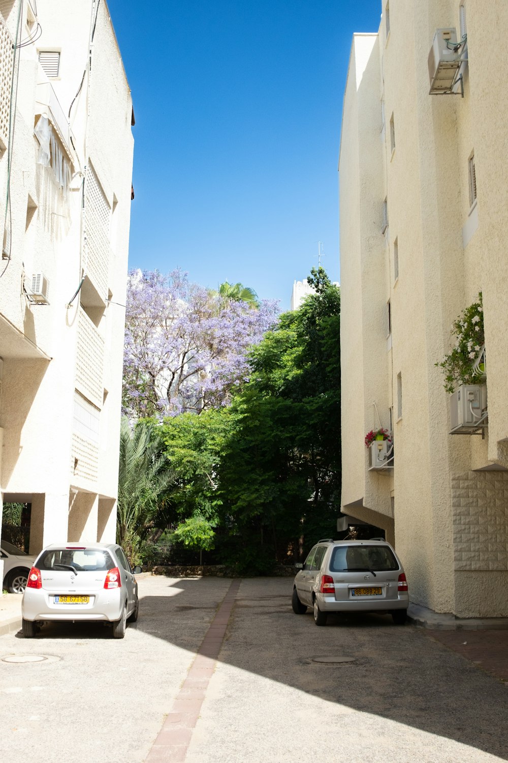 a couple of cars parked next to each other on a street