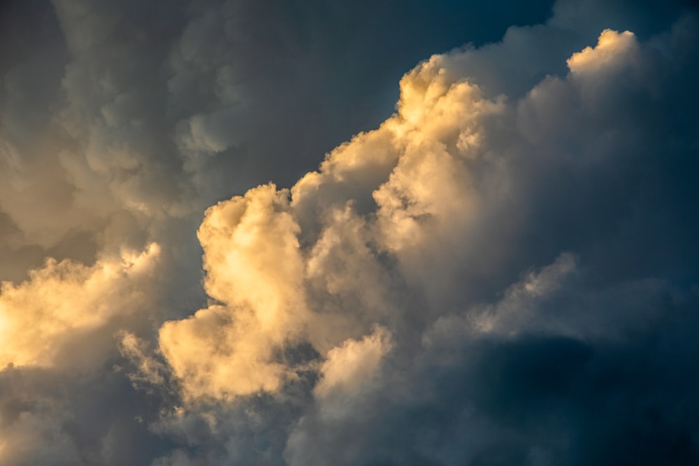 a plane flying in the sky with a lot of clouds