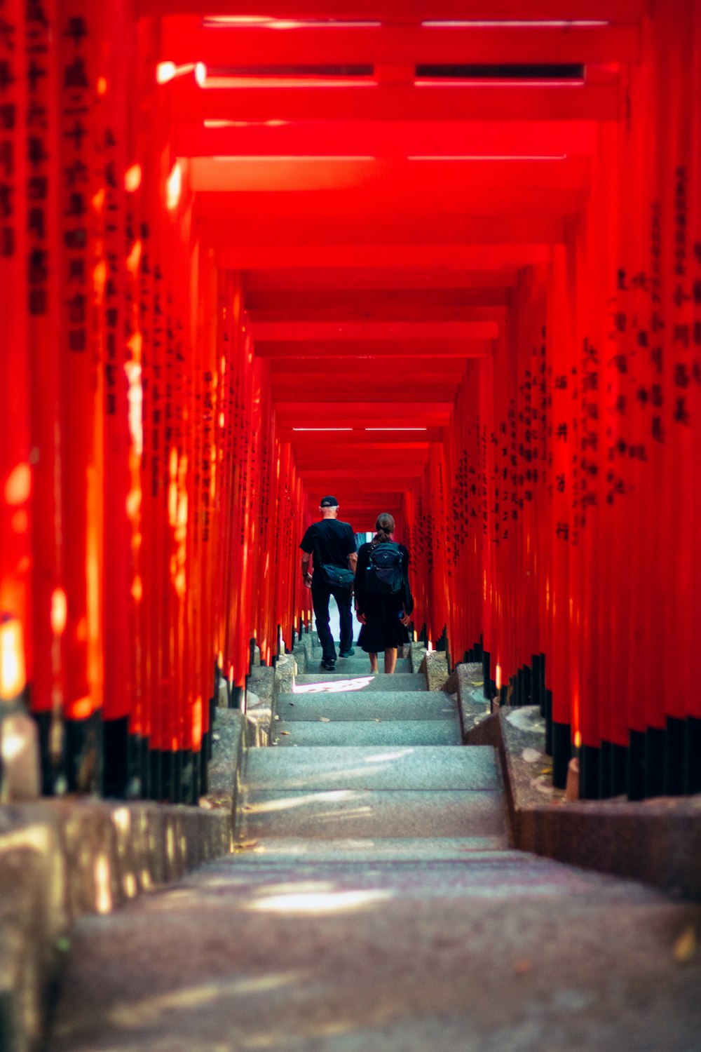 a couple of people walking down a set of stairs