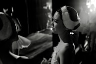 Behind-the-scenes moment of dancers preparing backstage, tying shoes and sharing encouraging smiles.