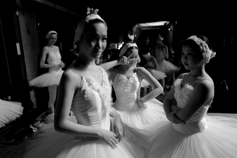 a group of young ballerinas standing next to each other