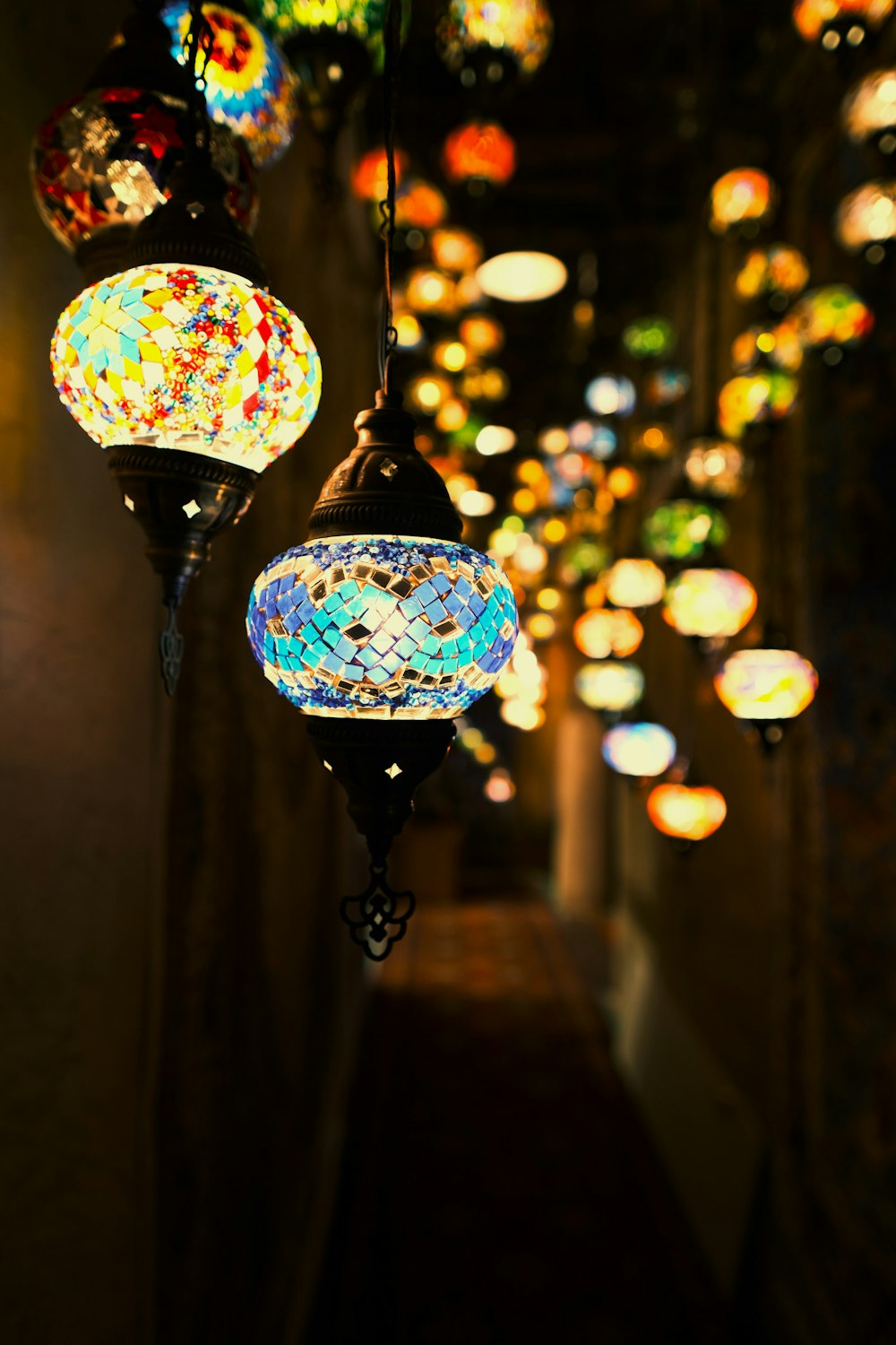 a group of colorful lights hanging from a ceiling