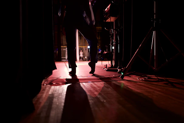 Backstage candid shot of an artist preparing before going on stage, showing focus and excitement.