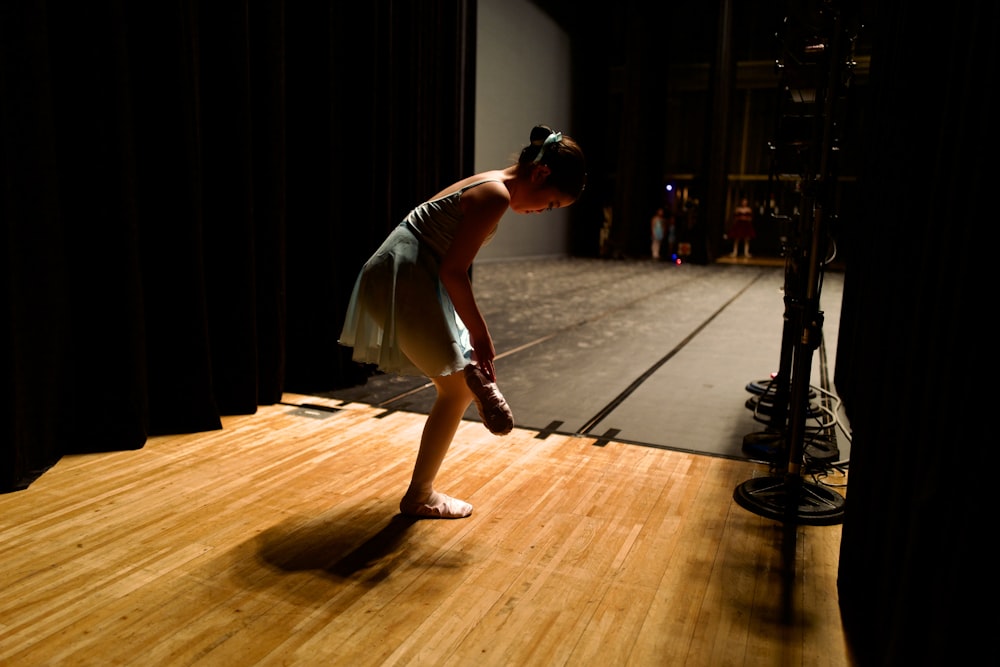 a woman standing on top of a wooden floor