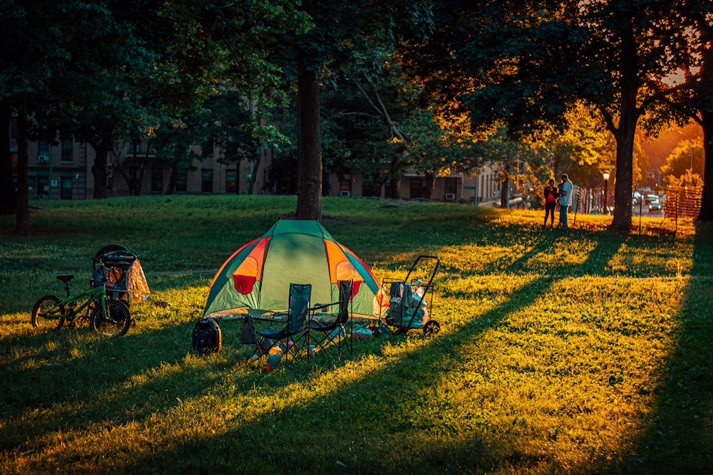 a tent is set up in a grassy field