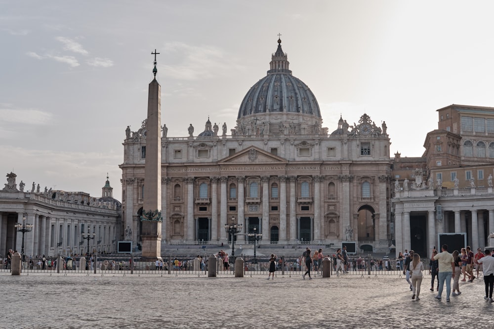 a group of people walking in front of a large building