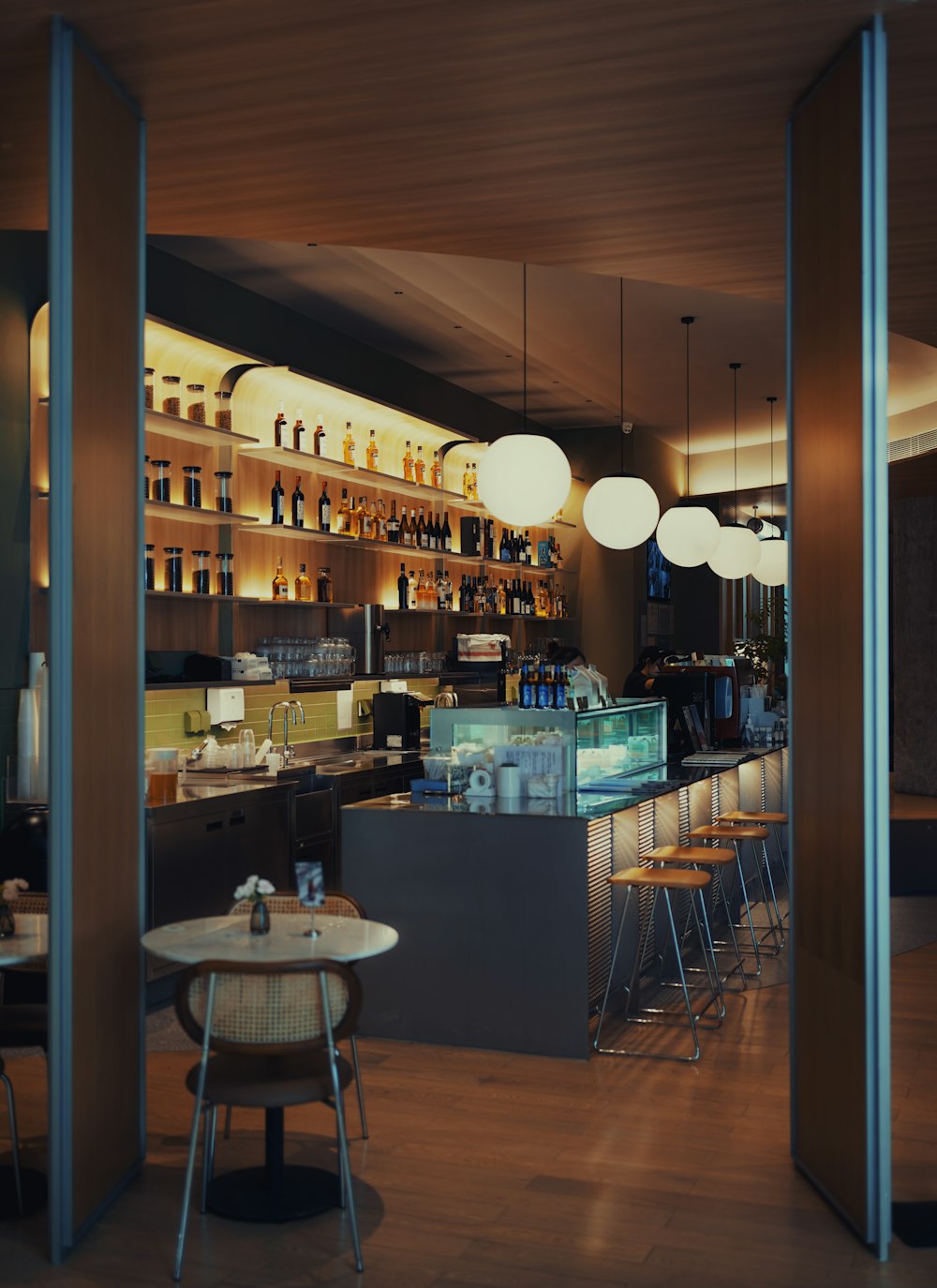 a dimly lit bar with stools and tables