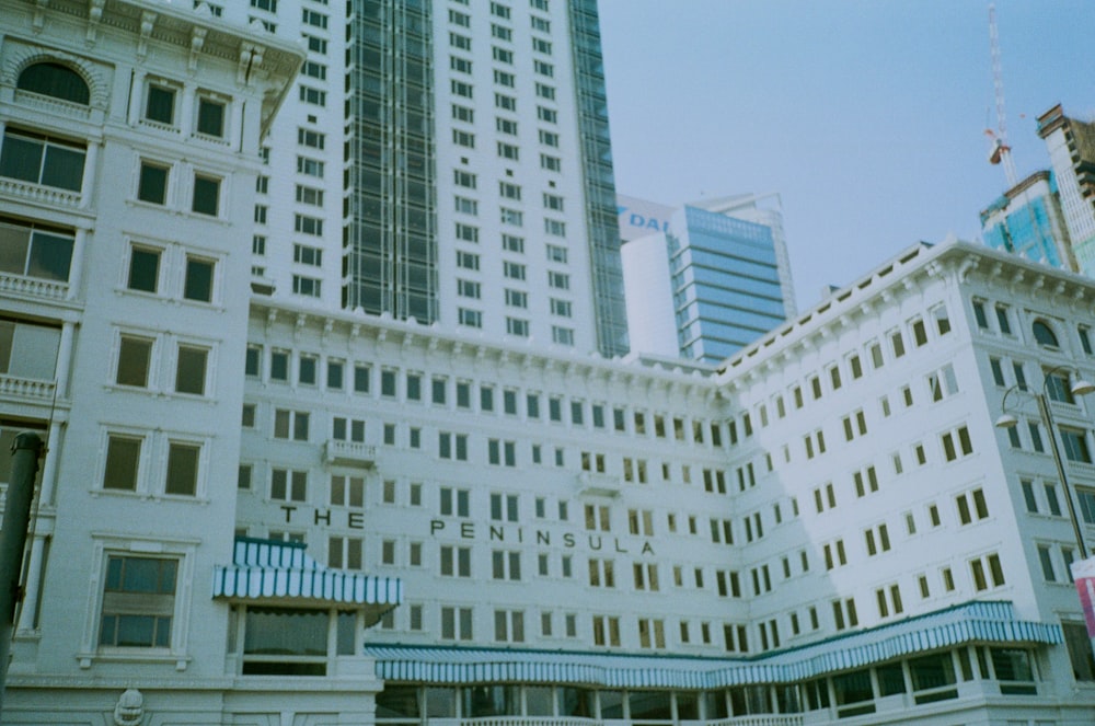 a group of tall buildings with a sky background