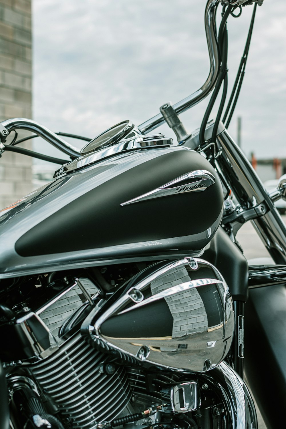 a black motorcycle parked next to a tall building