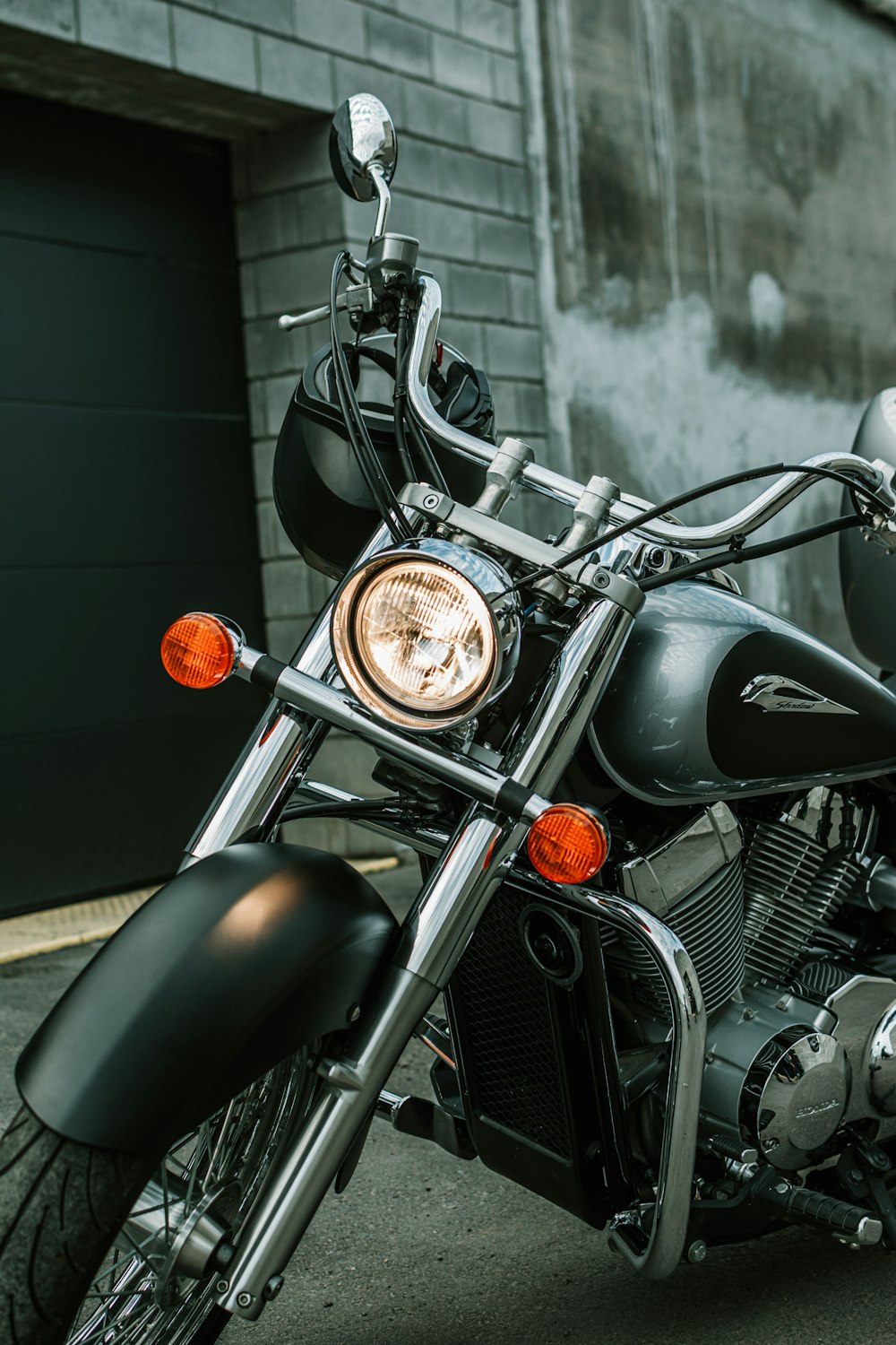 a black motorcycle parked in front of a building