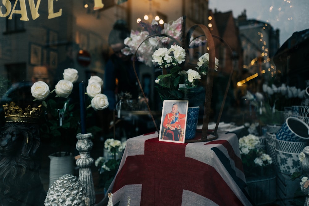 a british flag and flowers in a shop window
