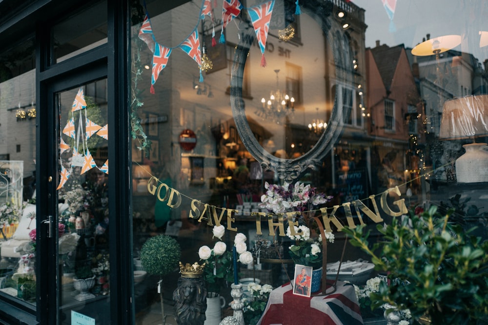 a store front with a bunch of flowers in the window