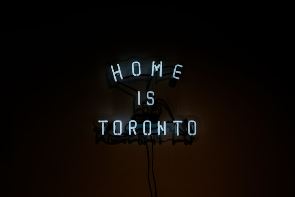 a neon sign that says home is toronto