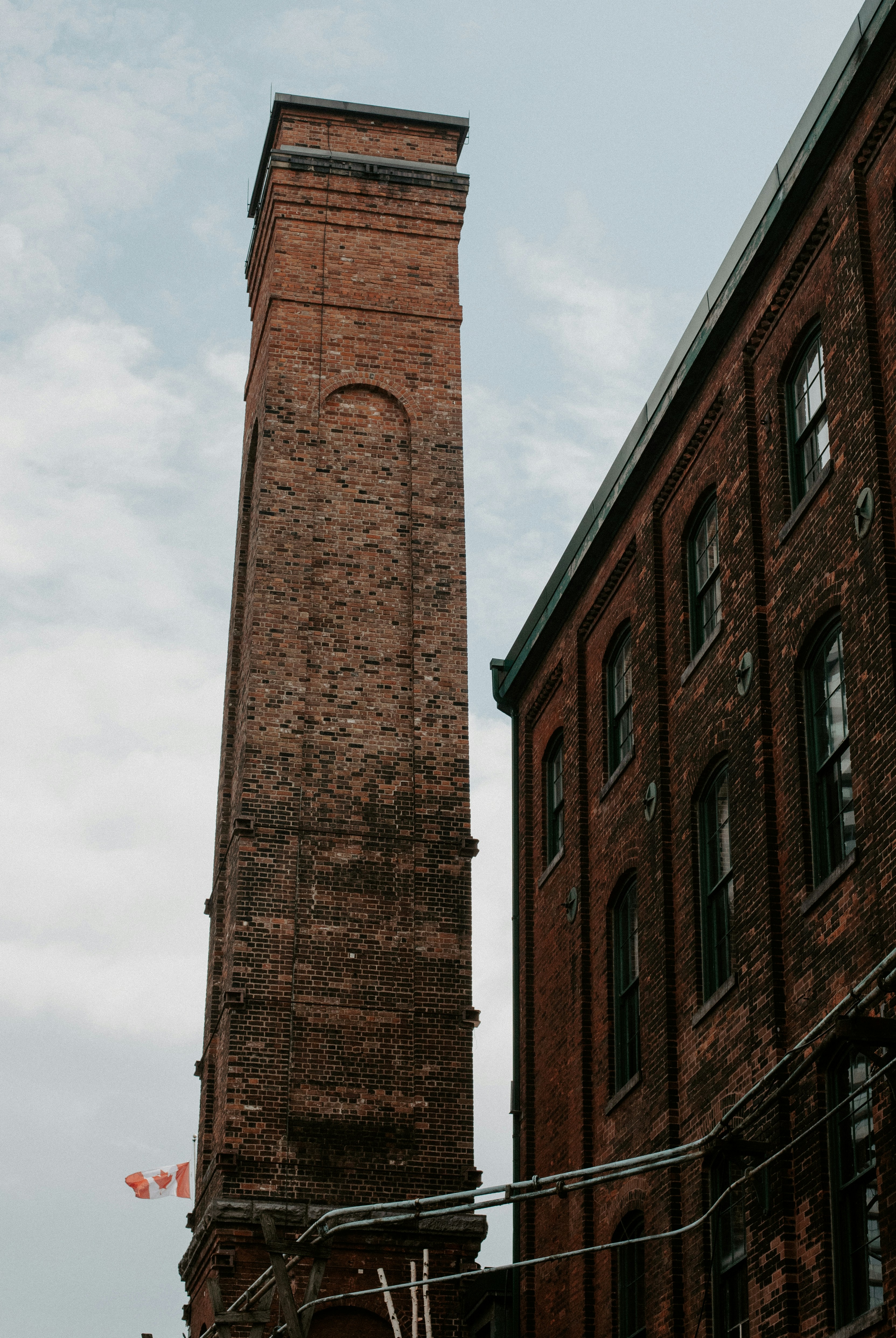 a tall brick clock tower towering over a city